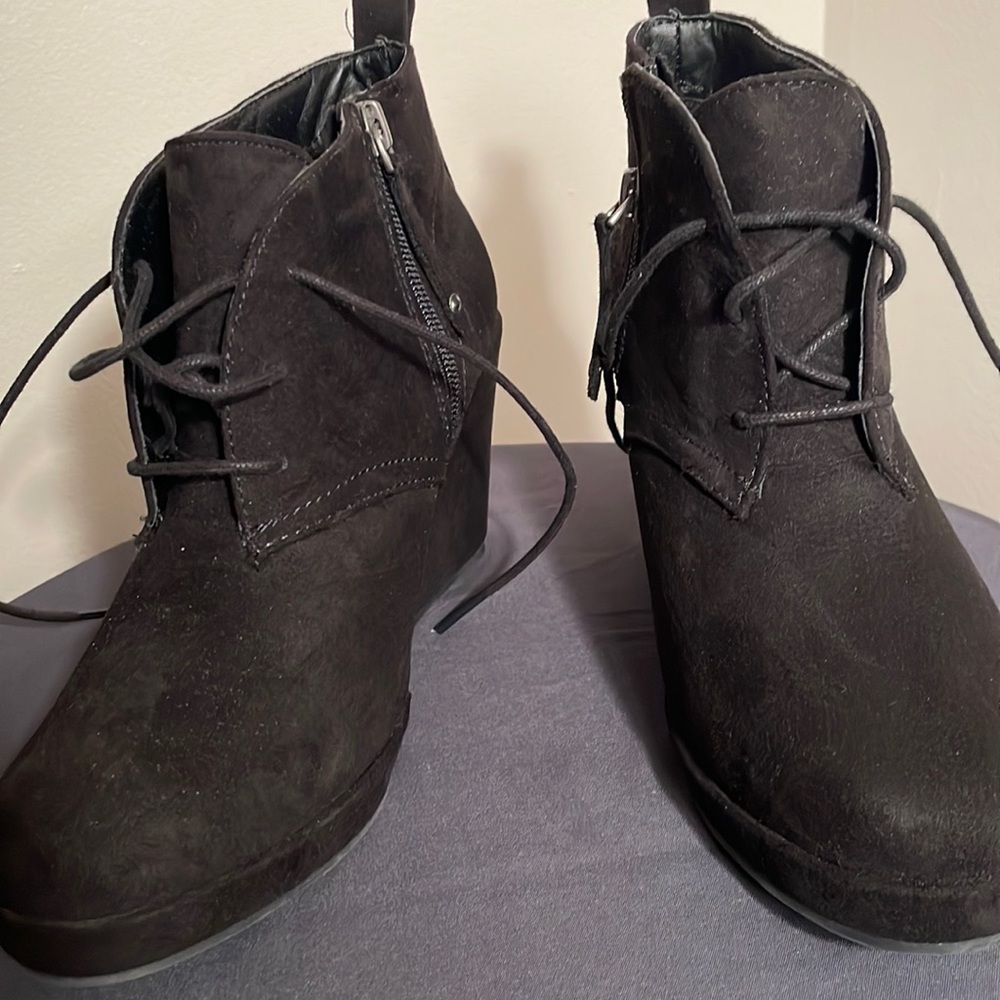 Black Wedges with zipper on the zip and laces. Size 7 very minimal wear.